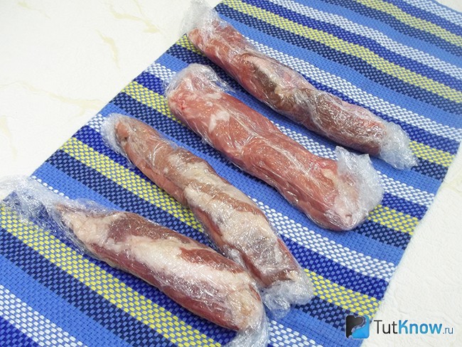 Мясо нарезано тонкой колбаской и обернуто пищевой пленкой