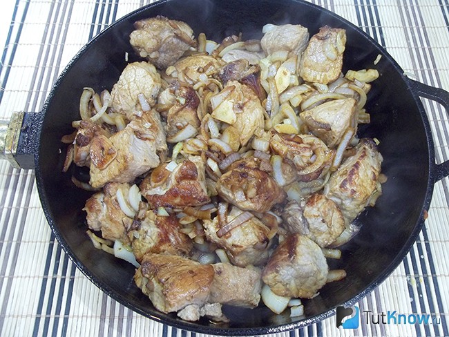 Мясо и лук жарятся на сковороде