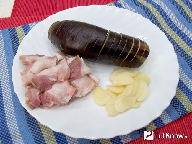 Сало с чесноком нарезаны слайсами, баклажан нарезан гармошкой