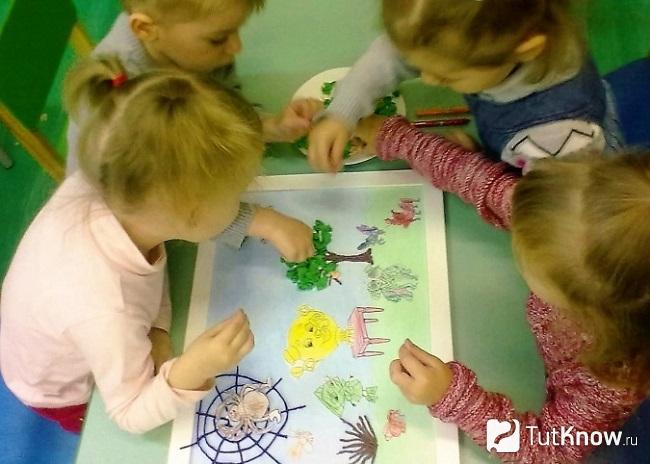 Четверо деток делают аппликацию