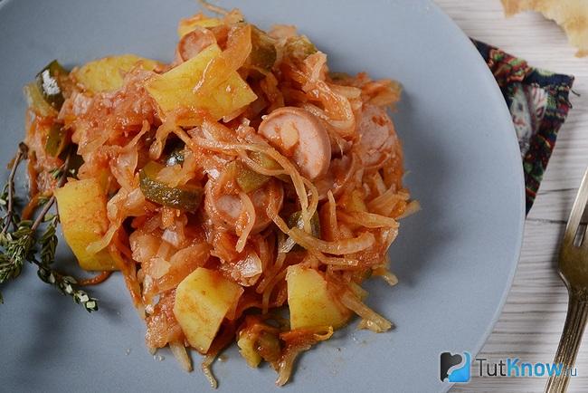 Солянка из квашеной капусты с сосисками и картошкой подана к столу
