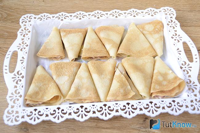 Блинчики с мясом выложены на подносе