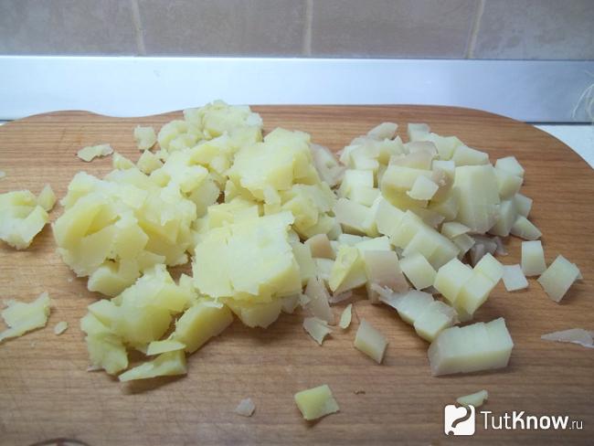 Отваренный картофель очищен и нарезан кубиками