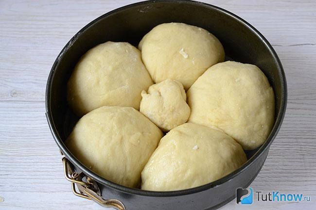 Кусочки теста с начинкой выложены в форму для запекания