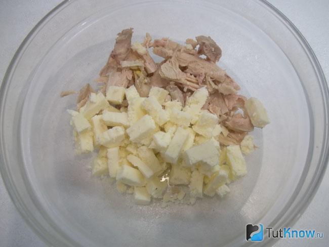 Сыр нарезан кусочками и добавлен к курице