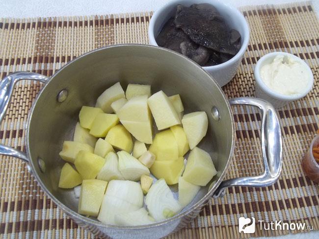 Картофель и лук очищены, нарезаны и сложены в кастрюлю