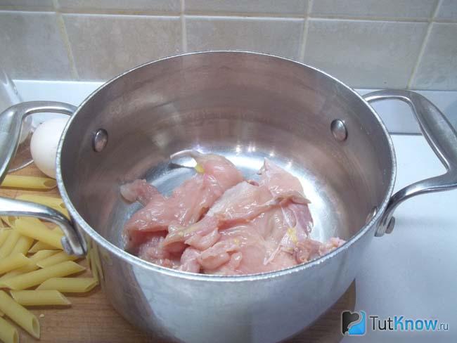 Куриное филе нарезано и сложено в кастрюлю