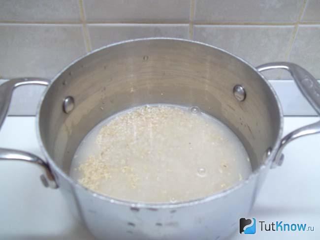 Крупа насыпана в кастрюлю и залита водой