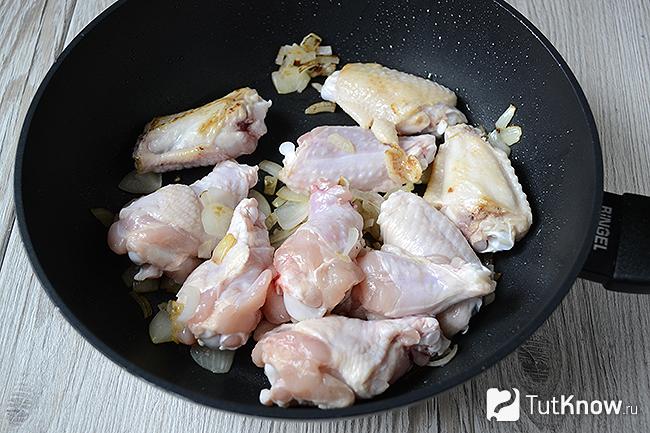 Куриные крылышки жарятся на сковороде